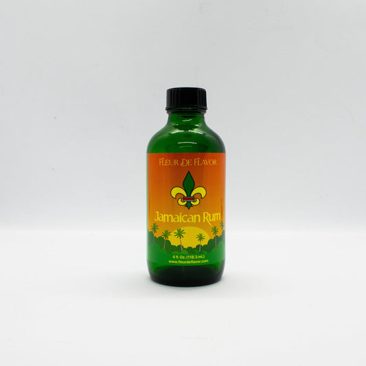 Fleur De Flavor Jamaican Rum Flavor in a 4 fl oz green bottle with tropical label, ideal for baking cakes, cookies, and candies without alcohol.