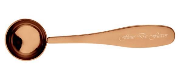 Close-up of Fleur De Flavor Rose Gold Teaspoon showing engraved branding on handle, combining elegance and precision for baking enthusiasts.